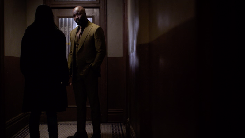 Mike Colter as Luke Cage saying hello to Krysten Ritter as Jessica Jones.
